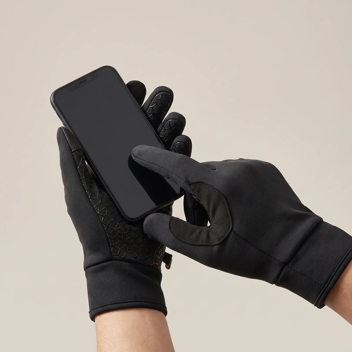 Gloved index finger operating a smartphone