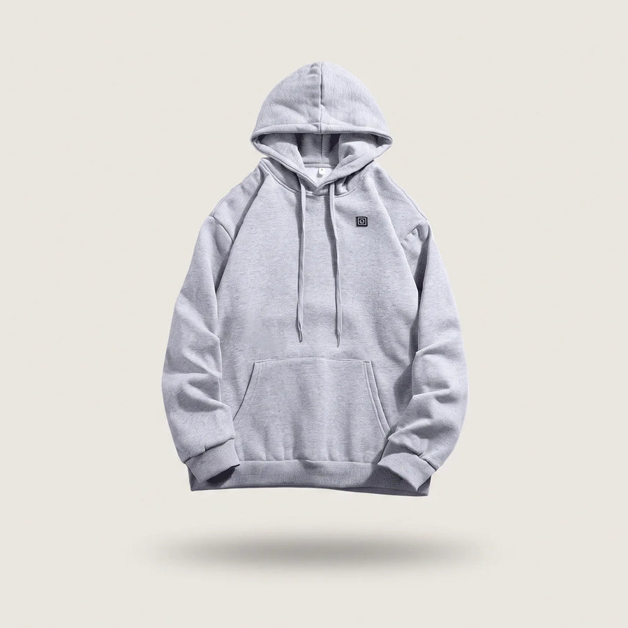 Beheizter Hoodie BergHeat Hütte in Grau mit Kapuze, Kordeln und Heizknopf auf der Brust